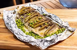 Grilled Norwegian cod in papillote with capers and asparagus