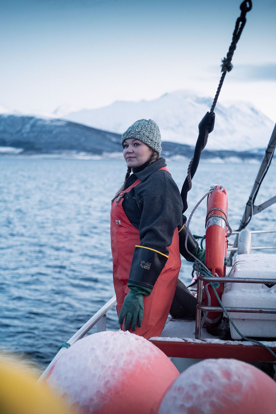 Fisherwoman in a boat on a Norwegian fiord