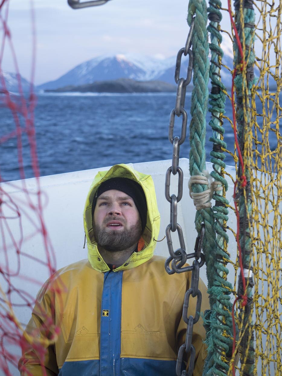 Fisherman watching the equipment on board the boat